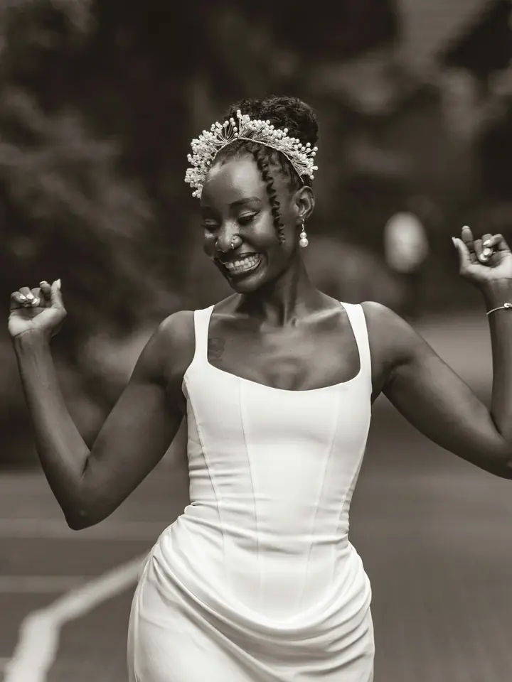 Bride dancing in a white dress, black and white
