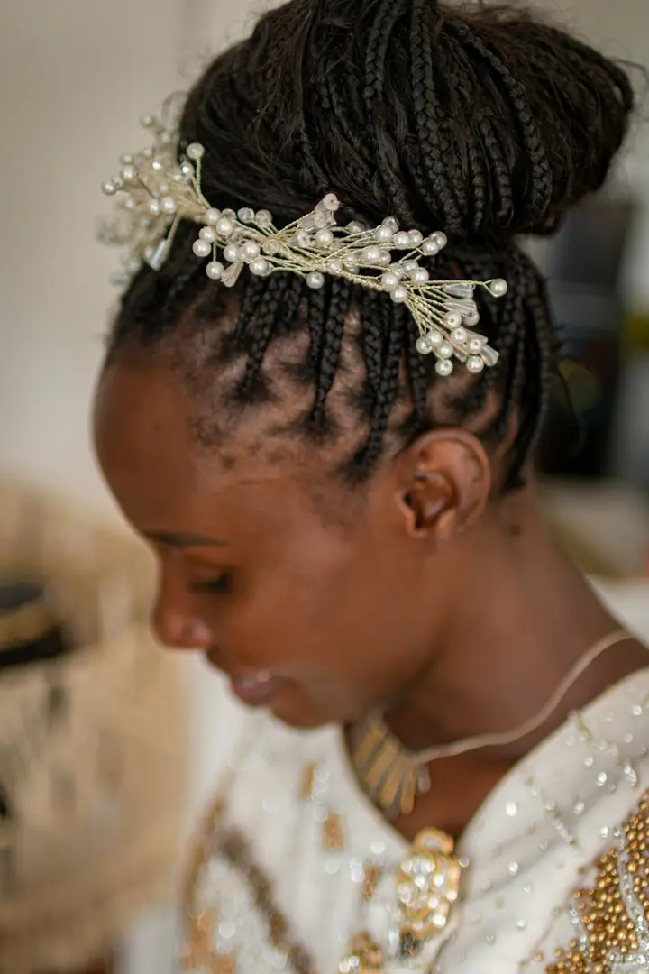 Close-up of a pearl bridal headpiece on braided hair